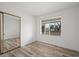 Bright bedroom with hardwood floors, sliding mirrored closet, and large window at 710 Copper Ln # 102, Louisville, CO 80027