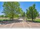 Neighborhood park with sidewalk, grassy lawn, trees and bike racks at 710 Copper Ln # 102, Louisville, CO 80027