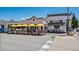 Charming storefronts of huckleberry restaurant and other businesses with outdoor seating under bright yellow umbrellas at 710 Copper Ln # 102, Louisville, CO 80027