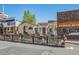 Street view of Zucca restaurant and Wildwood Guitars with outdoor patio seating and charming architecture at 710 Copper Ln # 102, Louisville, CO 80027