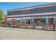 Main St Marketplace, view of Brewery & Pub restaurant with charming outdoor seating under colorful umbrellas on a sunny day at 710 Copper Ln # 102, Louisville, CO 80027