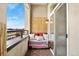 Relaxing private balcony with outdoor seating and city views, featuring wood flooring and privacy screen at 277 N Broadway # 409, Denver, CO 80203