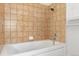 Close-up view of a bathtub with light-colored square tile surround at 277 N Broadway # 409, Denver, CO 80203