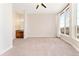 Neutral bedroom featuring carpet, ceiling fan, and natural light from large windows at 277 N Broadway # 409, Denver, CO 80203