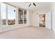 Bedroom with large windows, ceiling fan, and doorway to kitchen area at 277 N Broadway # 409, Denver, CO 80203