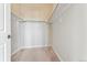 Walk-in closet with custom shelving, rod system, and carpeted flooring at 277 N Broadway # 409, Denver, CO 80203