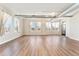 Bright living room with hardwood floors, multiple windows with city views, and exposed ductwork at 277 N Broadway # 409, Denver, CO 80203