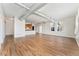 Spacious living room with wood laminate flooring, exposed duct work, and kitchen access at 277 N Broadway # 409, Denver, CO 80203