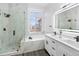 This modern bathroom features a glass shower, soaking tub, and double vanity with modern fixtures at 17161 E Dewberry Dr, Parker, CO 80134