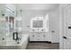 A sleek bathroom features a glass shower, soaking tub, and double vanity with illuminated mirrors at 17161 E Dewberry Dr, Parker, CO 80134