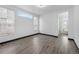 Spacious bedroom with a bathroom ensuite, light gray floors, and two large windows at 17161 E Dewberry Dr, Parker, CO 80134