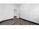 A well-lit bedroom featuring modern gray flooring, a white door, and a clean, minimalist aesthetic at 17161 E Dewberry Dr, Parker, CO 80134