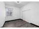 A bright bedroom with sleek gray flooring, a window with blinds, and a closet with sliding doors at 17161 E Dewberry Dr, Parker, CO 80134