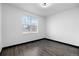 Bright bedroom with a large window offering natural light and views, complemented by stylish gray flooring at 17161 E Dewberry Dr, Parker, CO 80134