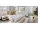 Bedroom featuring a cream-colored bed and white nightstands and decorative artwork at 17161 E Dewberry Dr, Parker, CO 80134