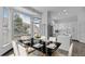 Elegant dining area with a modern chandelier and view into the bright, white kitchen at 17161 E Dewberry Dr, Parker, CO 80134