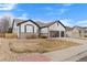 Charming home with attractive architectural details and a well-manicured front yard at 17161 E Dewberry Dr, Parker, CO 80134
