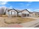 A beautiful home with a three-car garage, green grass, and tasteful landscaping at 17161 E Dewberry Dr, Parker, CO 80134