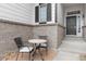 Cozy front porch seating area with a table and chairs for relaxing outdoors at 17161 E Dewberry Dr, Parker, CO 80134