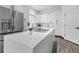 Modern kitchen boasts white cabinetry, stainless appliances, and a large center island at 17161 E Dewberry Dr, Parker, CO 80134