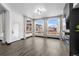Bright living room with large windows, a sleek fireplace, and light hardwood floors at 17161 E Dewberry Dr, Parker, CO 80134