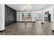Spacious living room with light grey flooring, large windows, and modern accent wall at 17161 E Dewberry Dr, Parker, CO 80134