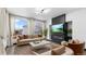 Bright living room featuring a modern fireplace, large windows, and stylish decor at 17161 E Dewberry Dr, Parker, CO 80134