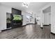 Open-concept living room featuring modern finishes, wood floors, and plenty of natural light at 17161 E Dewberry Dr, Parker, CO 80134