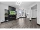 Open living room with fireplace and tv, leading to a modern kitchen with stainless steel appliances at 17161 E Dewberry Dr, Parker, CO 80134