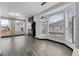 Bright living room features a modern fireplace, contemporary light fixture, and large windows offering plenty of natural light at 17161 E Dewberry Dr, Parker, CO 80134