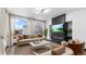 Staged living room featuring large windows, modern fireplace, and stylish decor at 17161 E Dewberry Dr, Parker, CO 80134