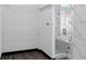 A spacious walk-in closet featuring wire shelving and a modern glass shower with mosaic tile flooring at 17161 E Dewberry Dr, Parker, CO 80134