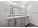 Bathroom features a double vanity with marble countertop and modern fixtures at 5202 Reed St, Arvada, CO 80002
