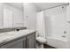 Clean bathroom with a single sink, a toilet, and a shower with white curtain at 5202 Reed St, Arvada, CO 80002