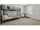 Cozy bedroom with a bunk bed, small table with two stools, and natural light at 5202 Reed St, Arvada, CO 80002