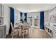 Cozy dining area with French doors, white table set for four, and ample natural light at 5202 Reed St, Arvada, CO 80002
