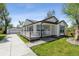 Charming home featuring a covered front porch and well-manicured lawn at 5202 Reed St, Arvada, CO 80002