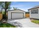 The property's white one-car detached garage, offering parking and storage at 5202 Reed St, Arvada, CO 80002