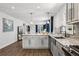 Open kitchen showcasing a large island, stainless steel sink, and an open-concept design at 5202 Reed St, Arvada, CO 80002