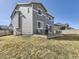 Spacious backyard with a patio, fire pit, outdoor seating and a well-maintained lawn under a clear blue sky at 5995 Fencerow Pl, Brighton, CO 80601