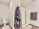 Well-lit bathroom with a glass-enclosed shower, toilet, and modern finishes, plus bathrobes at 5995 Fencerow Pl, Brighton, CO 80601