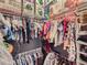 Walk-in closet, offering ample storage with multiple shelves and hanging racks for organized clothing at 5995 Fencerow Pl, Brighton, CO 80601