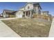 Charming two-story home featuring a front yard and three-car garage with beautiful curb appeal at 5995 Fencerow Pl, Brighton, CO 80601