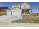 Charming two-story home featuring a three-car garage, inviting front porch, and beautiful curb appeal at 5995 Fencerow Pl, Brighton, CO 80601