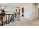 Upstairs hallway with dark wood railing and mounted deer head at 5995 Fencerow Pl, Brighton, CO 80601