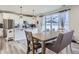 Bright kitchen with granite countertops, white cabinets, and a stainless steel refrigerator with glass doors to the yard at 5995 Fencerow Pl, Brighton, CO 80601