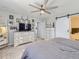 Comfortable main bedroom featuring a decorative ceiling fan and soft carpet with easy access to the ensuite at 5995 Fencerow Pl, Brighton, CO 80601