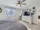 Comfortable main bedroom featuring a decorative ceiling fan and soft carpet with a chest of drawers at 5995 Fencerow Pl, Brighton, CO 80601
