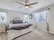 Bright main bedroom featuring a decorative ceiling fan and soft carpet with many windows at 5995 Fencerow Pl, Brighton, CO 80601