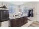 Bright office featuring a large wooden desk, a gun safe, and decor with a mounted deer head at 5995 Fencerow Pl, Brighton, CO 80601